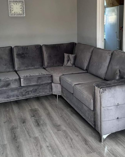 Alaska Double Corner Sofa in plush velvet fabric, featuring square arms and diamond button detailing.