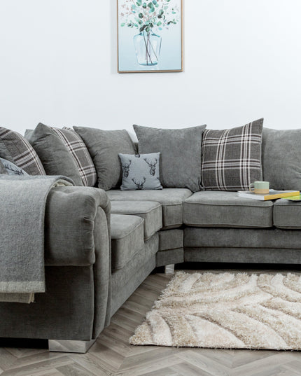 Verona modular corner sofa in grey with scatter-back cushions and stylish accessories on a cozy rug.
