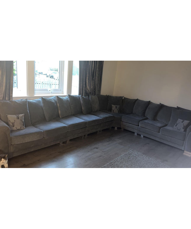 Verona 9-seater corner sofa in grey fabric, featuring soft cushions and a spacious design for comfort and relaxation.