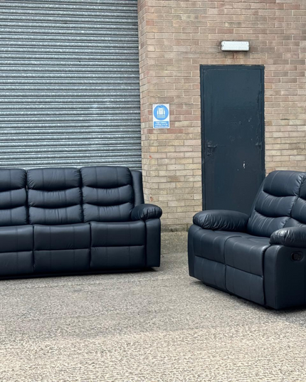Roma Series 2 Recliner 3+2 Seater Black Leather Sofa Set showcased outdoors against a brick background.