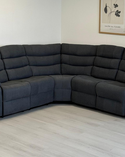 Sorrento corner recliner sofa in grey fabric, featuring plush cushions and manual reclining function.
