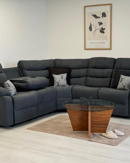 Sorrento corner recliner sofa in grey fabric with cushions and a modern coffee table.