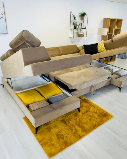 Sovereign U-shaped pull-out sleeper sofa in a stylish living room, highlighting plush velvet upholstery and storage.