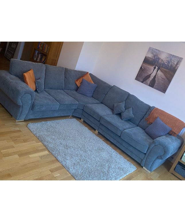 Vegas Corner Sofa 6 Seater in grey fabric, featuring cushions and a cozy design, perfect for relaxing in style.