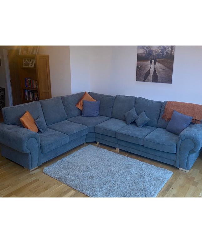 Vegas 6-seater corner sofa in grey fabric with decorative pillows, perfect for cozy living spaces.
