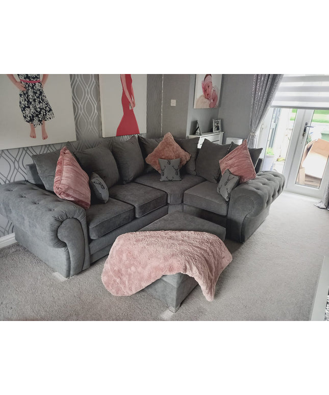Verona 4-seater corner sofa in grey with scatter back cushions and plush throw, enhancing a cozy living space.