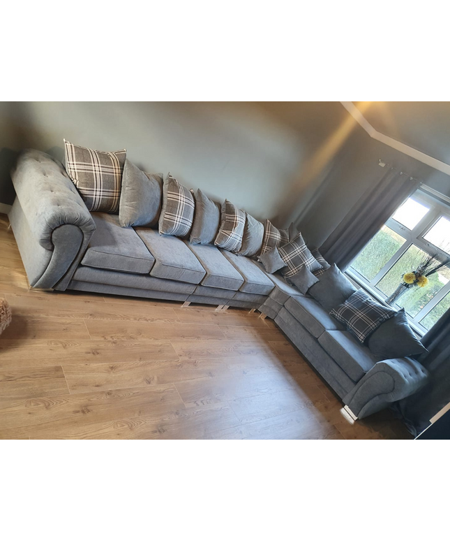 Verona corner sofa gray 7-seater with plaid scatter back cushions in a modern living room setting.