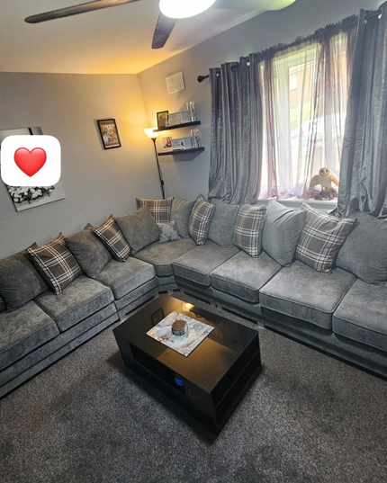 Spacious Verona modular corner sofa in grey with scatter back cushions in a cozy living room setting.