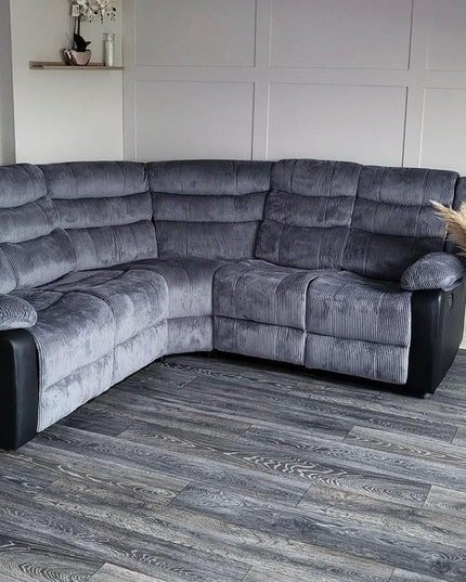 Rio recliner corner sofa in grey fabric with leather accents, featuring plush cushions and a modern design.
